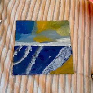 Painting of ocean with a unique sky